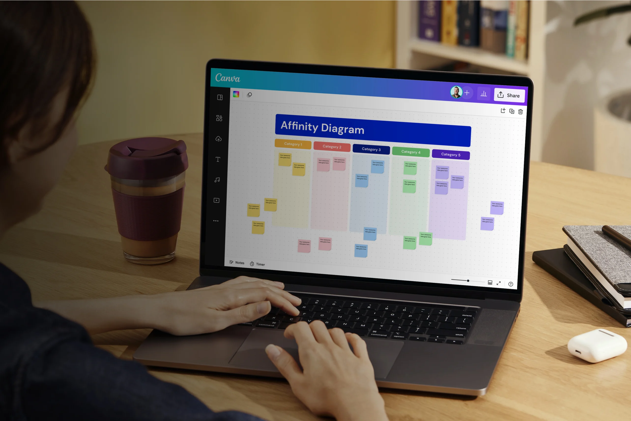 Laptop showing Dovetail affinity clusters alongside handwritten research notes
